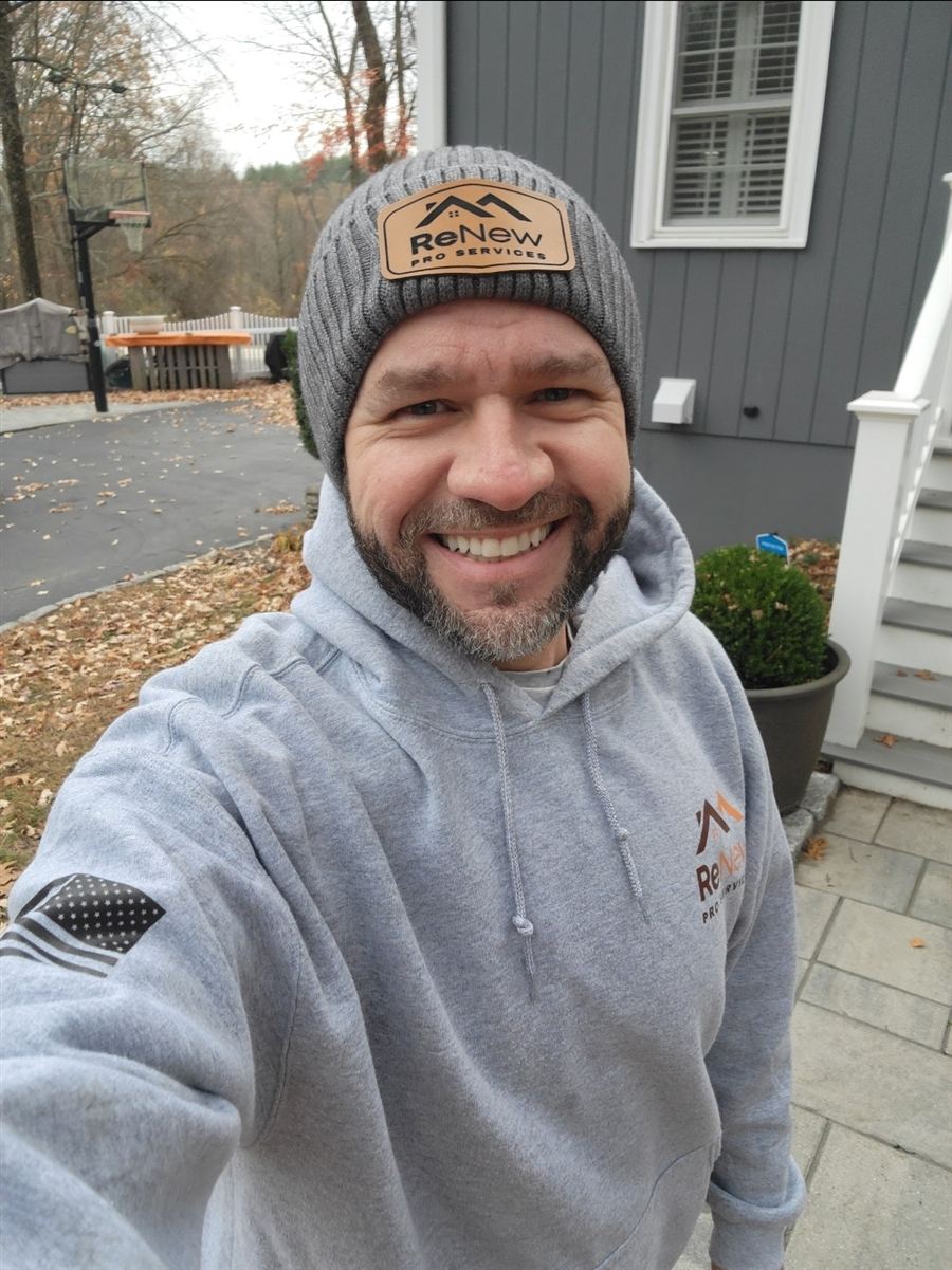 Isac Da Silva, owner of Renew Pro Services, smiling in a Renew Pro beanie and hoodie